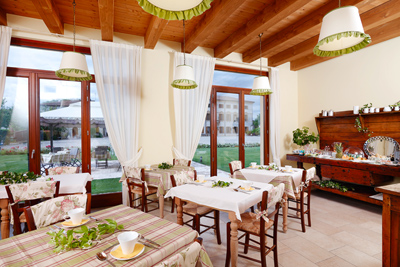 Room where an Italian-style breakfast is served outdoors in summer