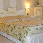 Provençal-style bedroom interiors with custom furniture at the Otto Ducati d’Oro country hotel and bed and breakfast